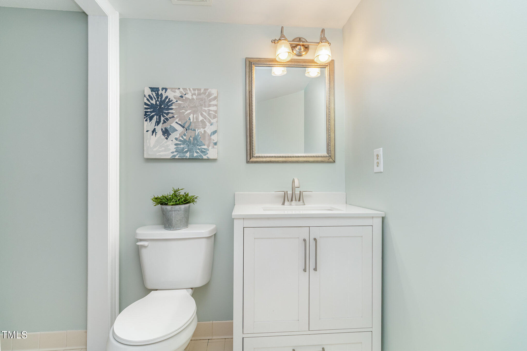 7050 Sandy Forks Road, Unit 101 Raleigh, NC 27615 - Photo 9 of 23 a bathroom with a toilet sink and mirror