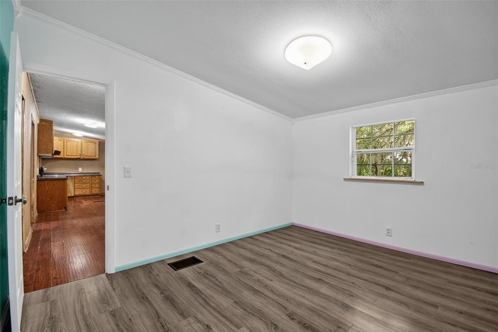 156 Kingfish Road Pomona Park, FL 32181 - Photo 41 of 55 a view of an empty room with wooden floor and a window