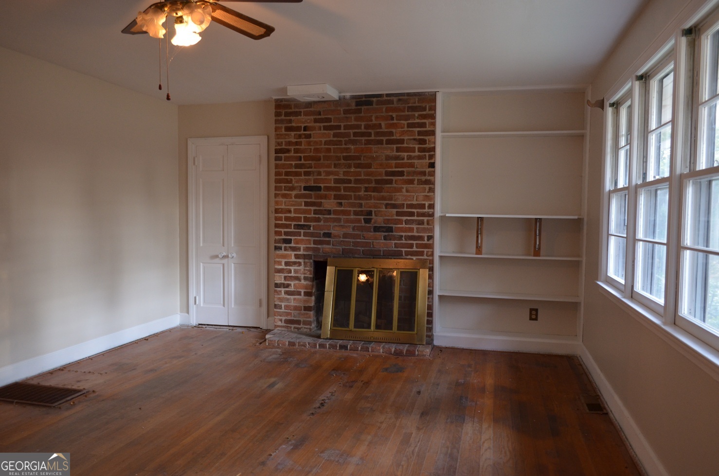 2655 Riverview Road Macon, GA 31204 - Photo 3 of 14 a view of an empty room with wooden floor and a window