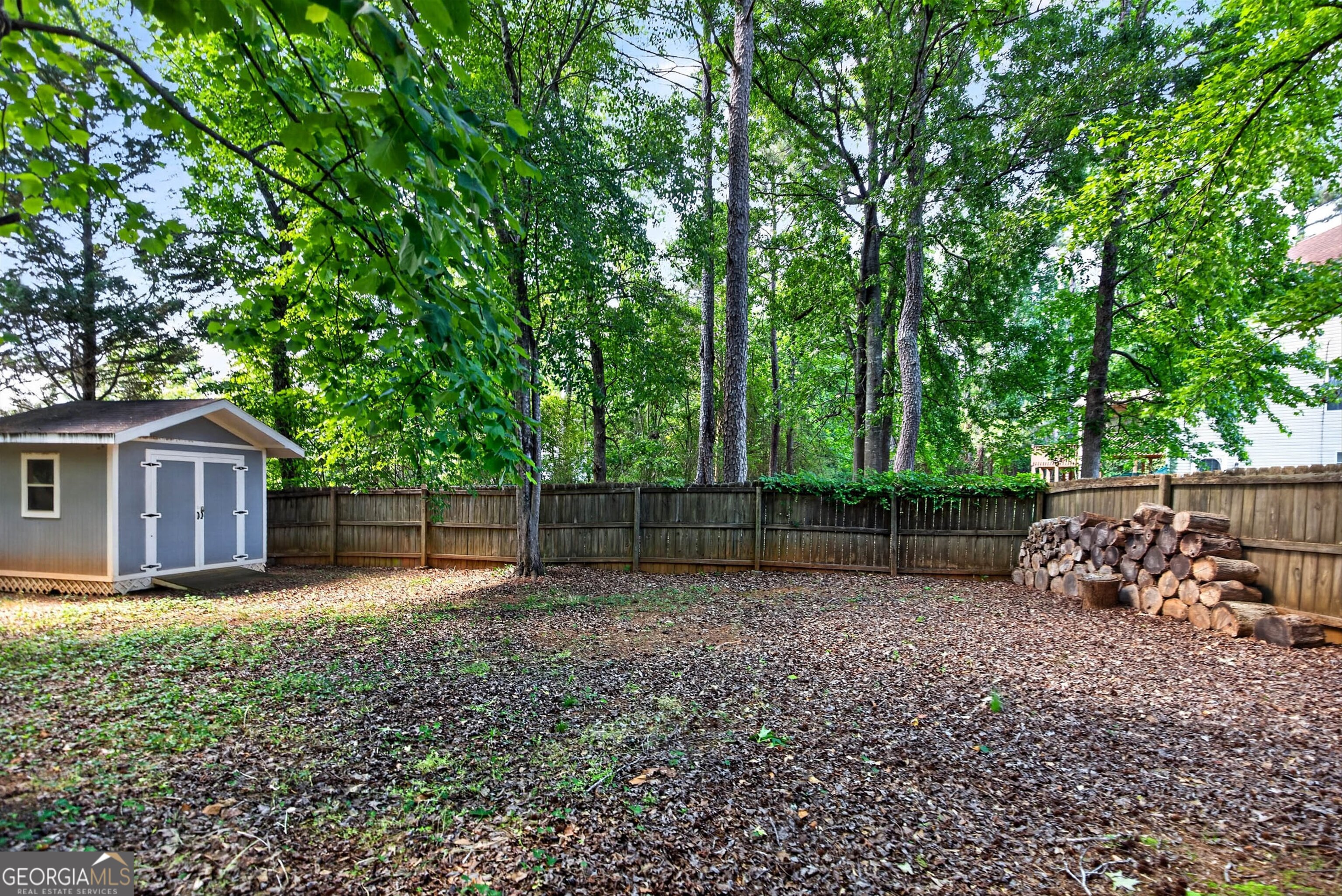 101 Emerald Lane Hampton, GA 30228 - Photo 55 of 72 a view of a backyard with a small cabin and a chair