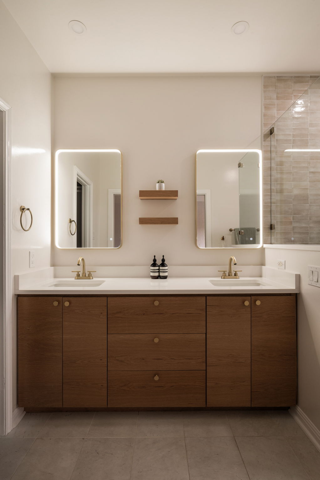 6501 Sumac Drive Austin, TX 78731 - Photo 17 of 40 Full bathroom featuring double vanity, light tile patterned flooring, and tiled shower