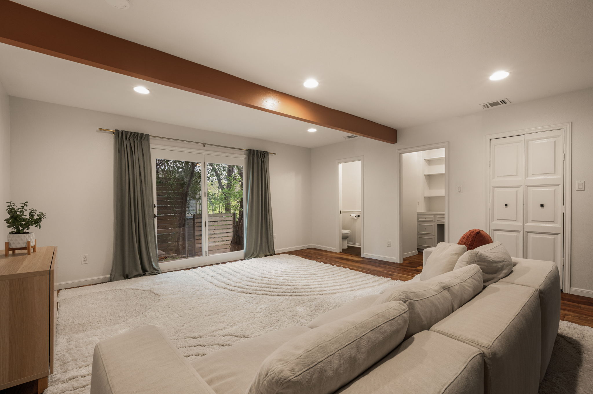 6501 Sumac Drive Austin, TX 78731 - Photo 19 of 40 Bedroom with recessed lighting, beamed ceiling, a spacious closet, ensuite bathroom, and wood finished floors