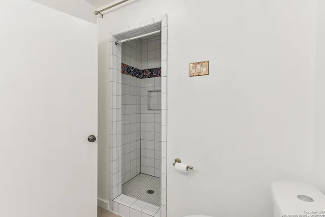 a bathroom with a shower and a sink