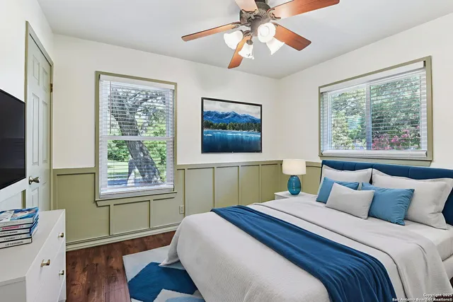 a bedroom with a large bed and a window