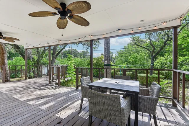 a view of a patio with a table chairs and a floor to ceiling window