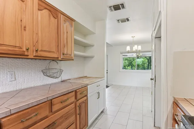a view of a kitchen with cabinets and a wooden floor