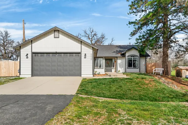 a front view of a house with yard patio and green space