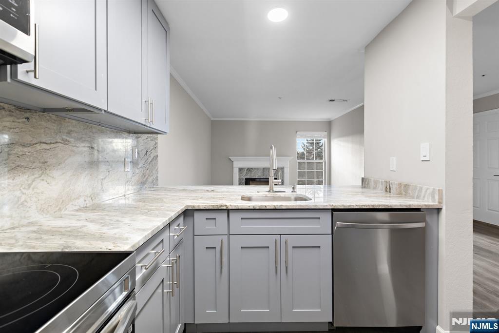 690 Rt 23 Wayne, NJ 07470 - Photo 4 of 11 a kitchen with granite countertop a sink and cabinets