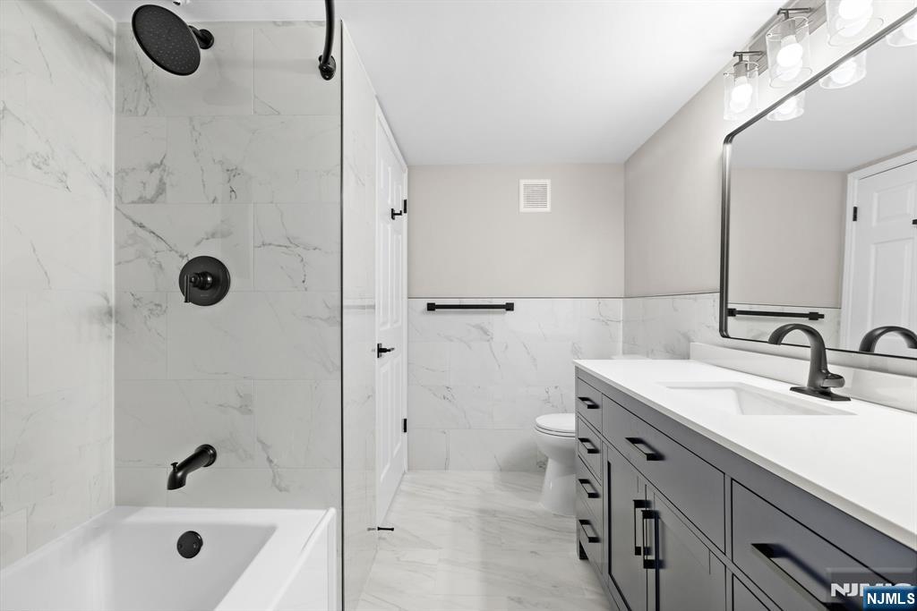 690 Rt 23 Wayne, NJ 07470 - Photo 9 of 11 a bathroom with a granite countertop sink a mirror and shower