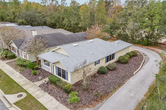 an aerial view of a house with a yard