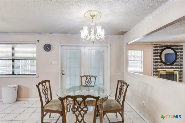 a view of a dining room with furniture and window