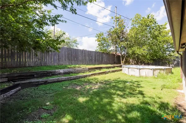 a view of a backyard with a small pool