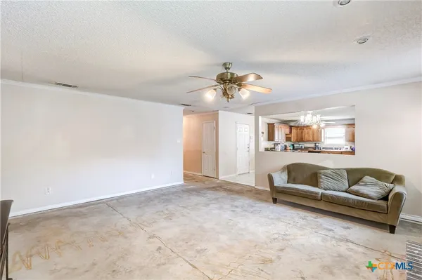 a living room with furniture and a chandelier