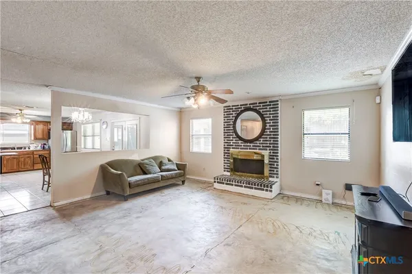 a living room with furniture a fireplace and a large window