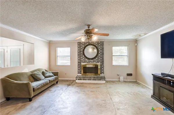 a living room with furniture a fireplace and a flat screen tv