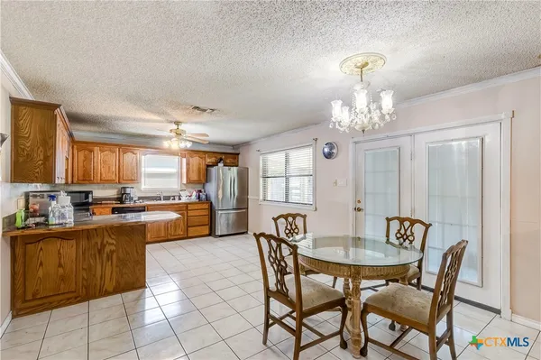 a view of a dining room with furniture and chandelier