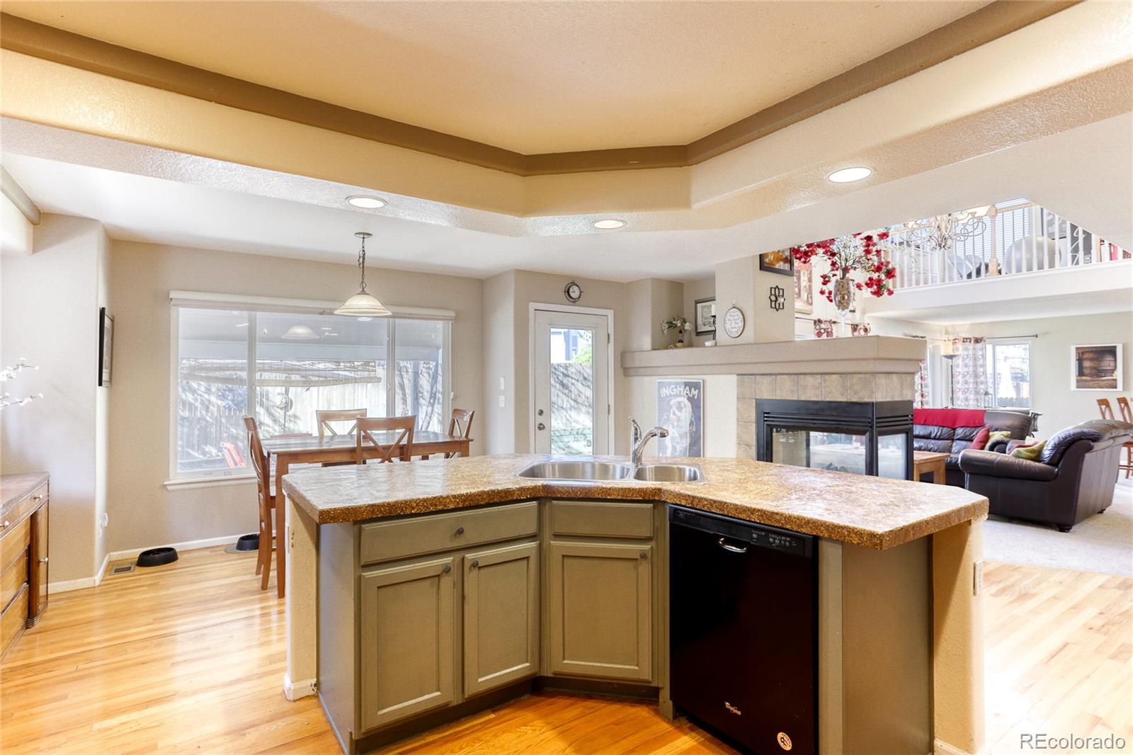 4425 Iran Street Denver, CO 80249 - Photo 11 of 36 a kitchen with a sink stove and cabinets