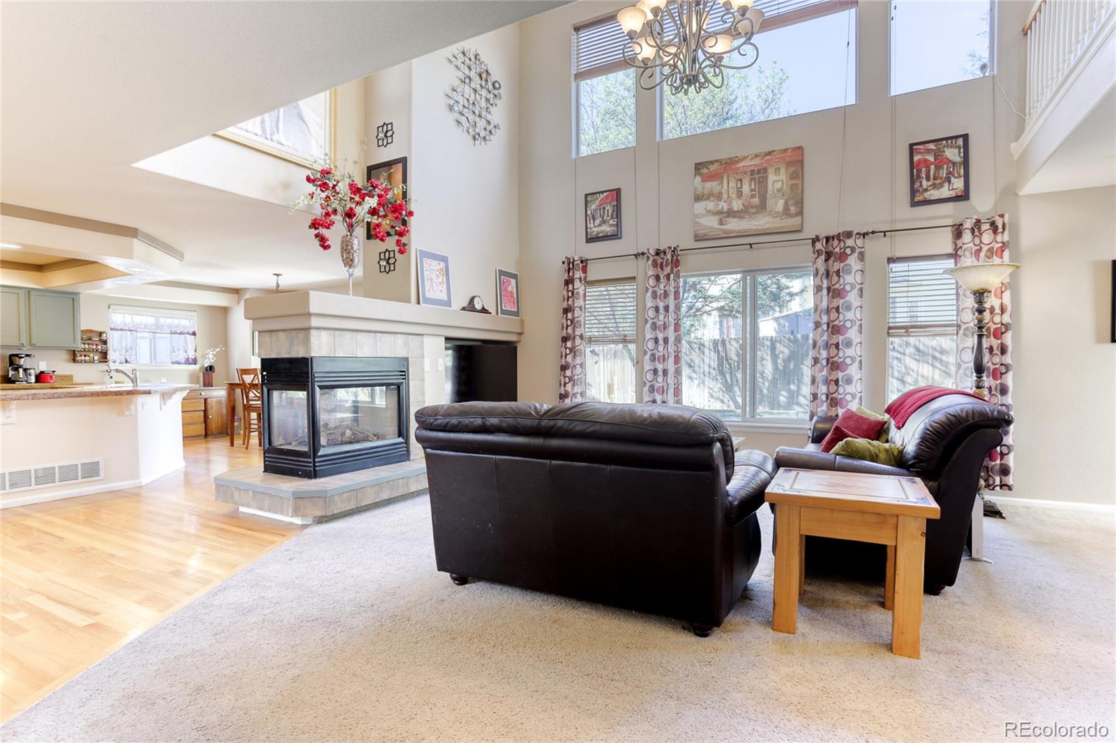 4425 Iran Street Denver, CO 80249 - Photo 12 of 36 a living room with furniture and a chandelier