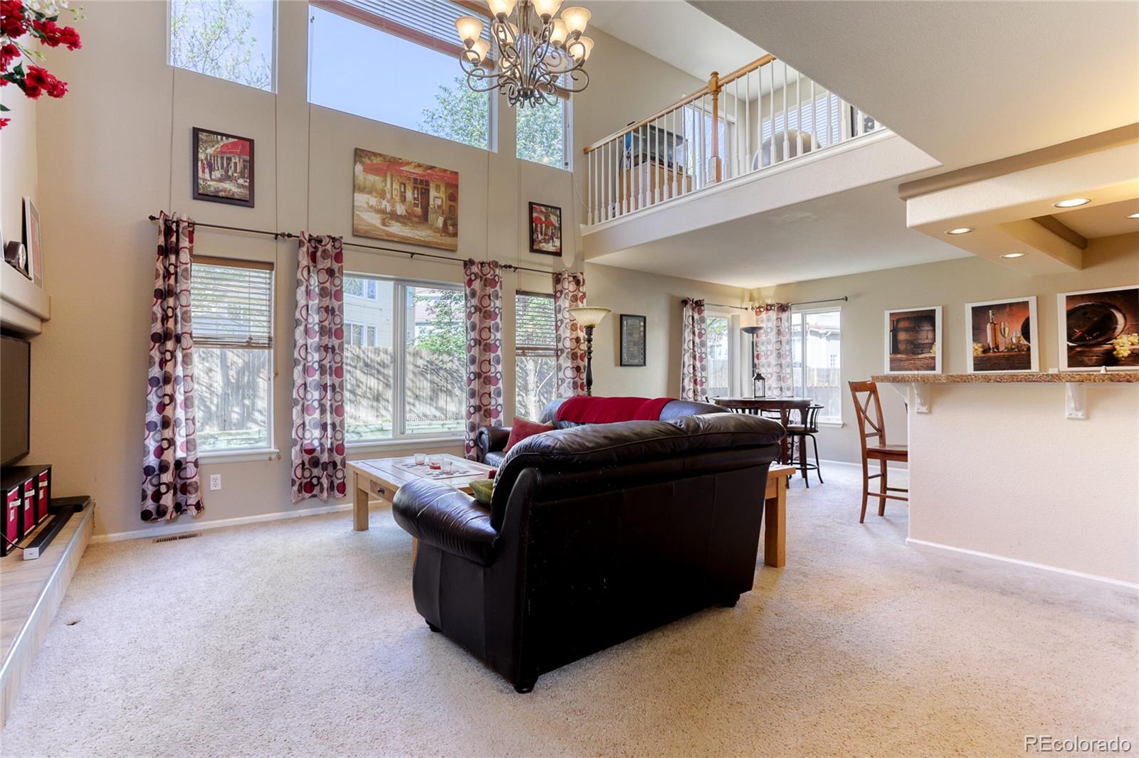 4425 Iran Street Denver, CO 80249 - Photo 14 of 36 a living room with furniture and a large window