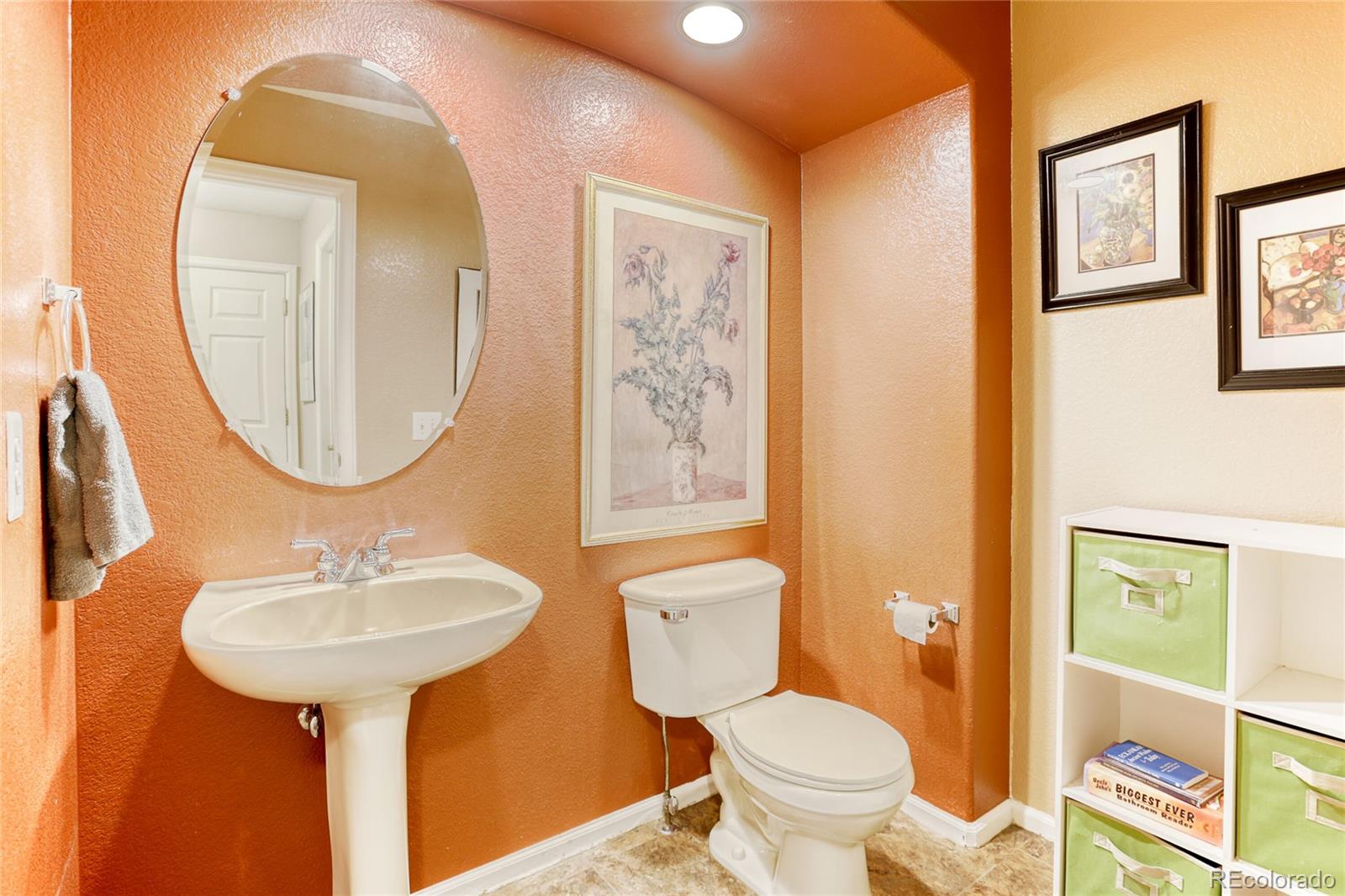 4425 Iran Street Denver, CO 80249 - Photo 16 of 36 a bathroom with a toilet sink and mirror