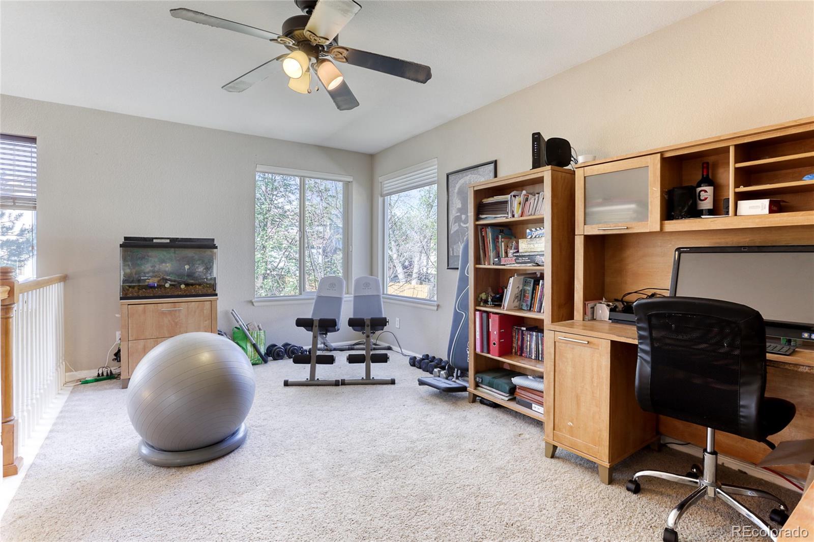 4425 Iran Street Denver, CO 80249 - Photo 19 of 36 a living room with workspace and a window