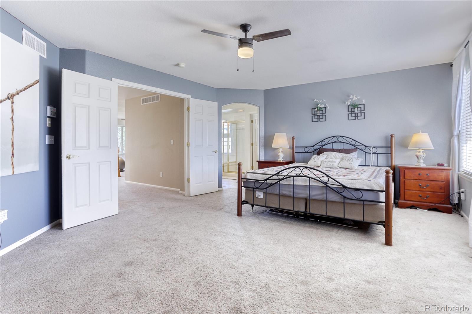 4425 Iran Street Denver, CO 80249 - Photo 20 of 36 a bedroom with bed and a chandelier