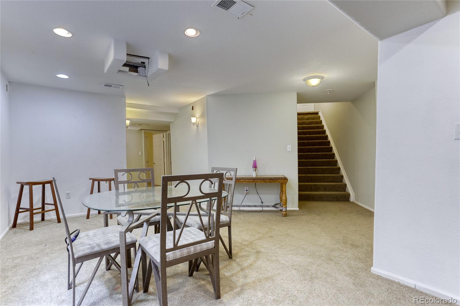 4425 Iran Street Denver, CO 80249 - Photo 24 of 36 a view of a room with furniture and stairs