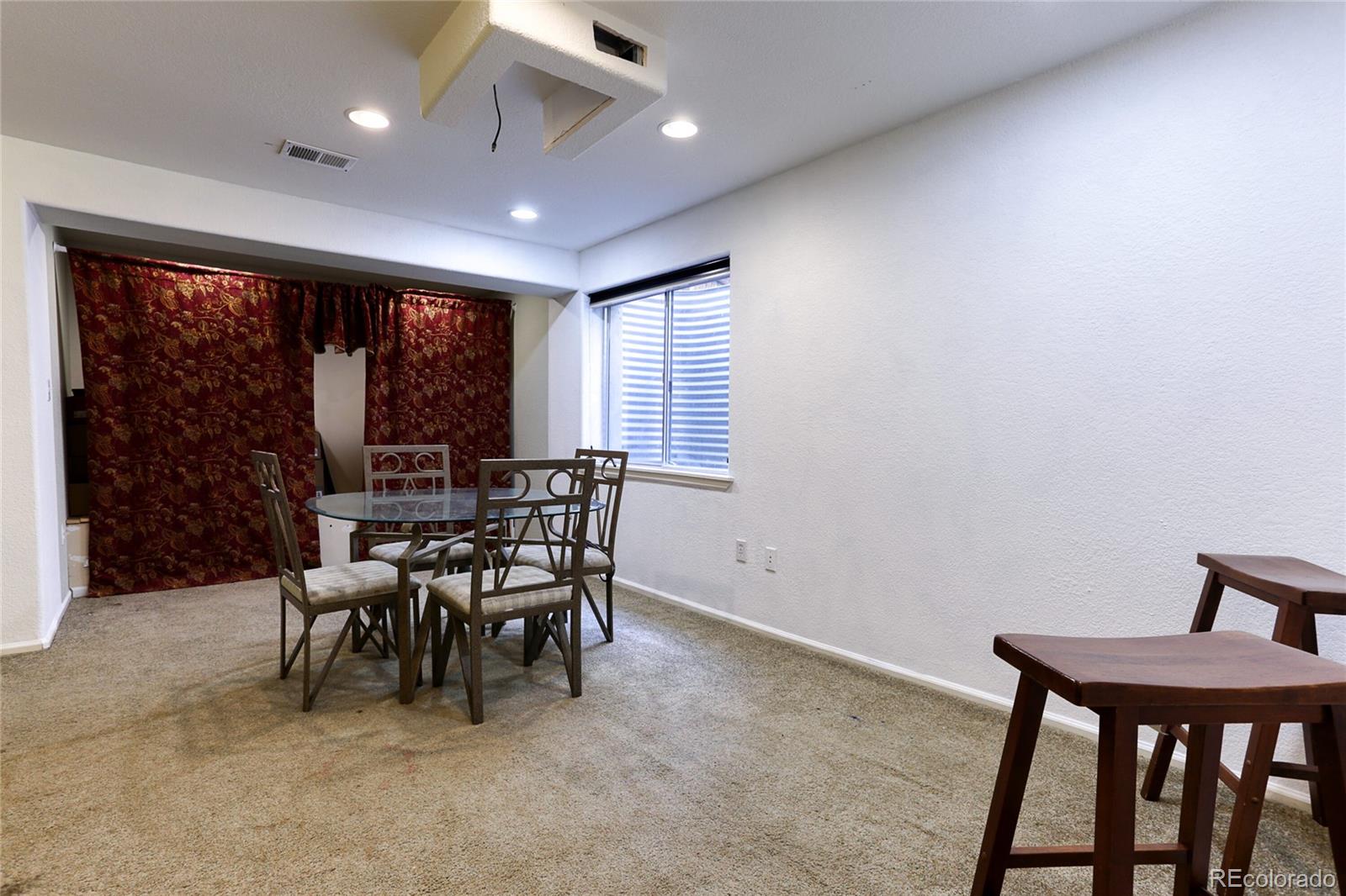 4425 Iran Street Denver, CO 80249 - Photo 25 of 36 a dining room with furniture and a floor to ceiling window