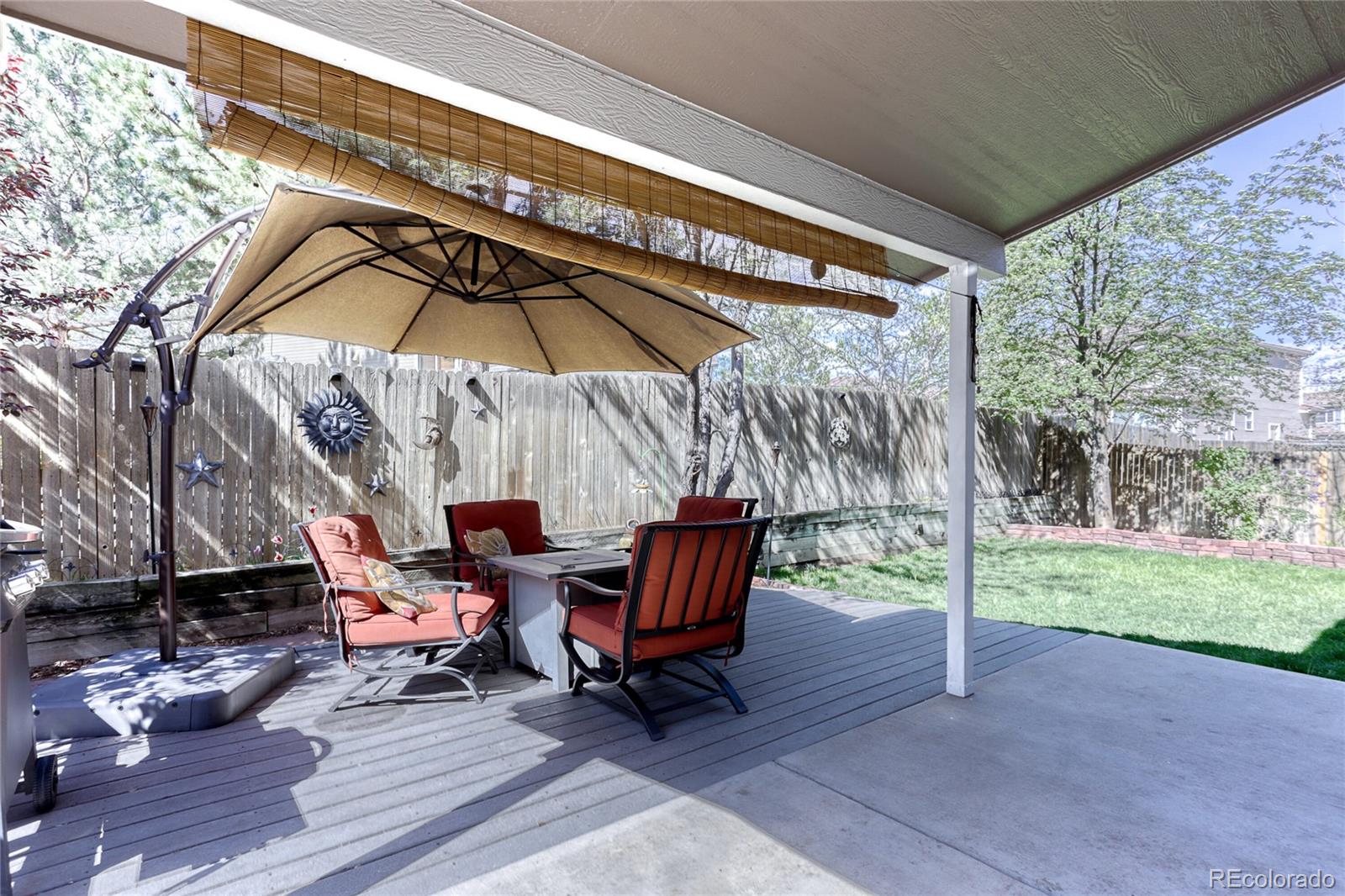 4425 Iran Street Denver, CO 80249 - Photo 32 of 36 a view of deck with chairs and table under an umbrella