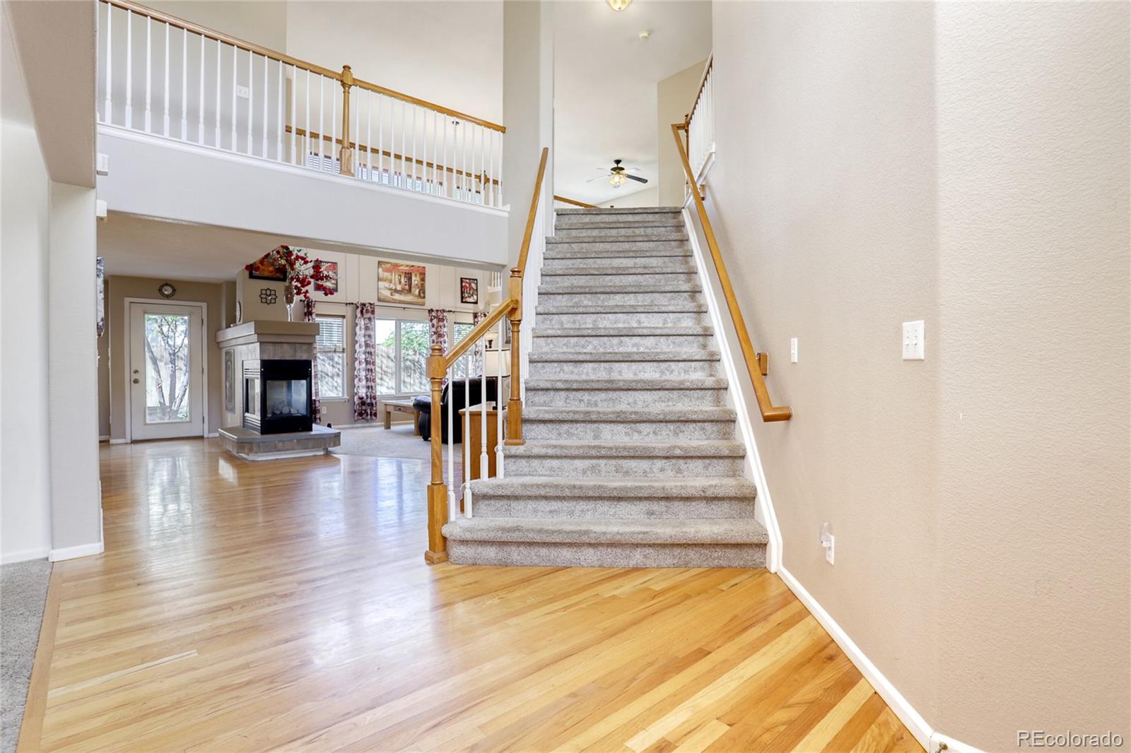 4425 Iran Street Denver, CO 80249 - Photo 4 of 36 a view of entryway and hall with wooden floor