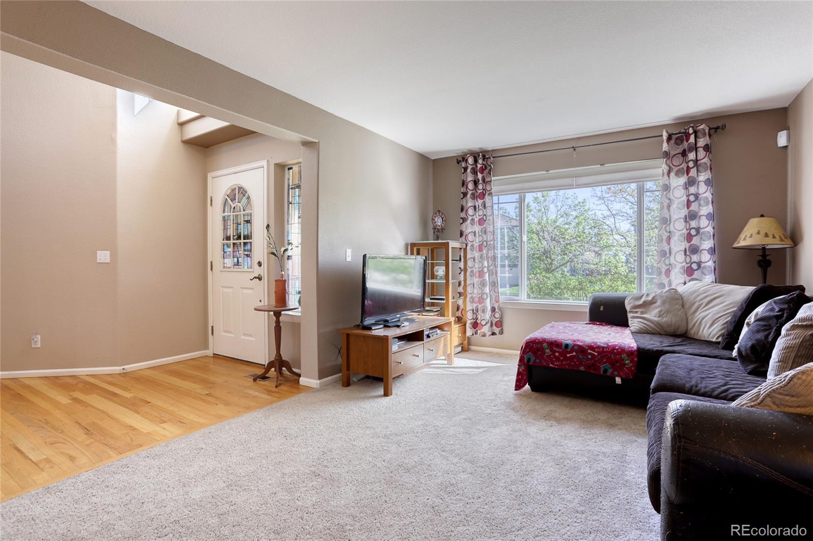 4425 Iran Street Denver, CO 80249 - Photo 5 of 36 a bedroom with furniture and a large window