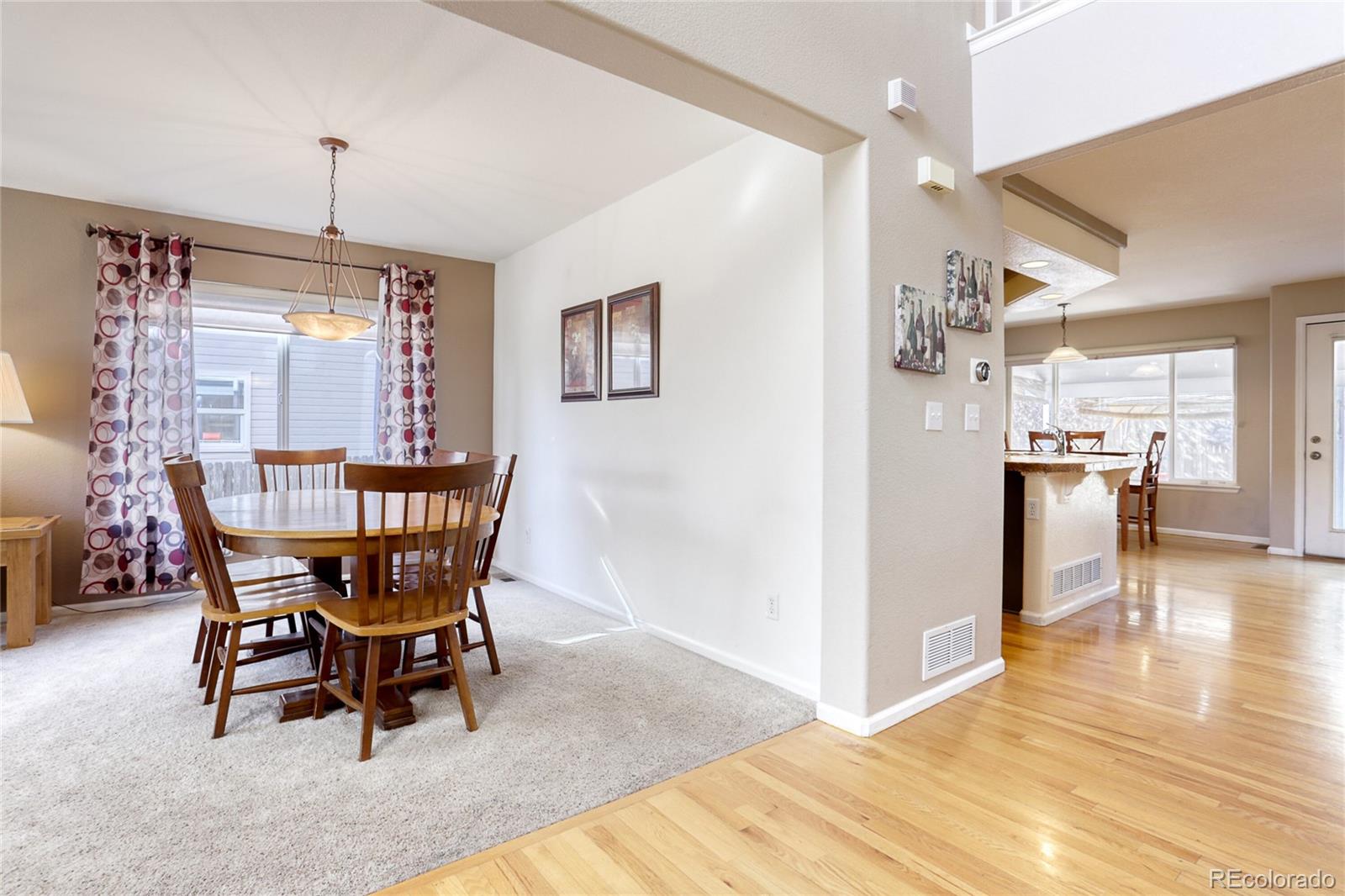 4425 Iran Street Denver, CO 80249 - Photo 7 of 36 a view of a dining room with furniture window and wooden floor