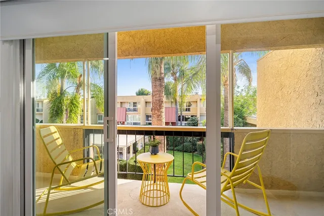 a room with furniture and large windows