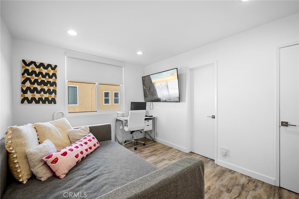 5435 Yarmouth Avenue, Unit 7 Encino, CA 91316 - Photo 21 of 31 a bedroom with furniture and a window