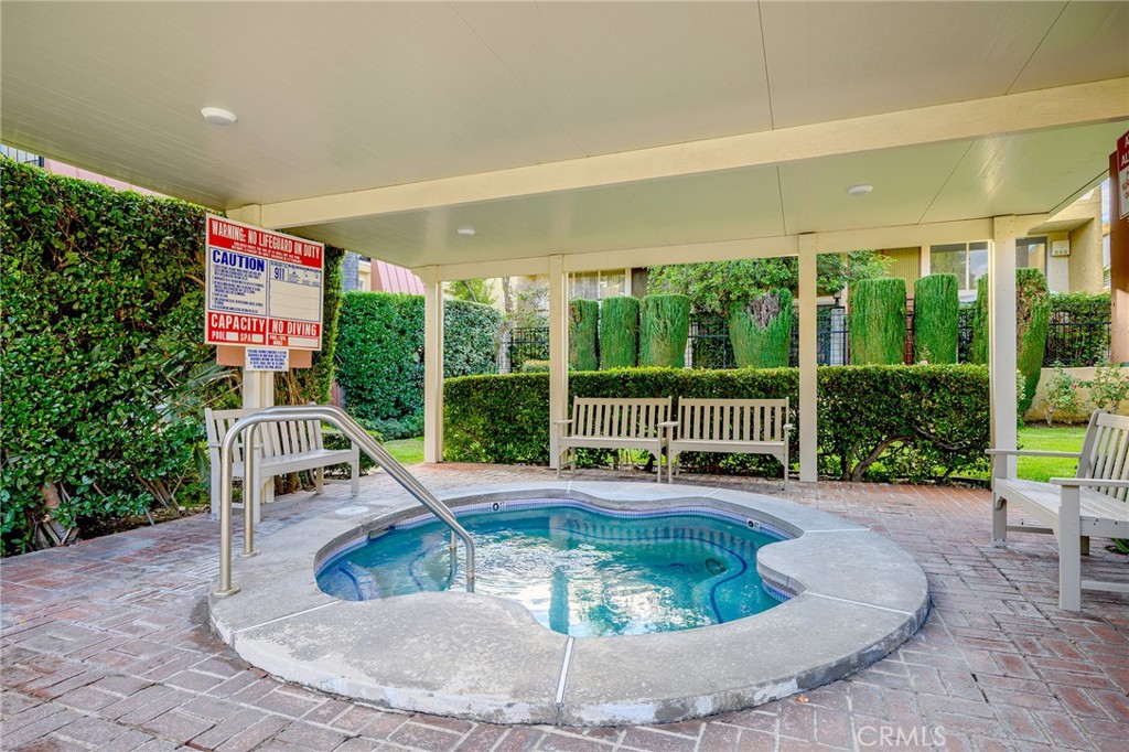 5435 Yarmouth Avenue, Unit 7 Encino, CA 91316 - Photo 30 of 31 a view of a house with swimming pool and garden in the background