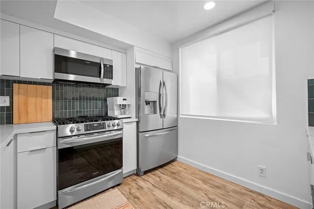 a kitchen with a stove microwave and refrigerator