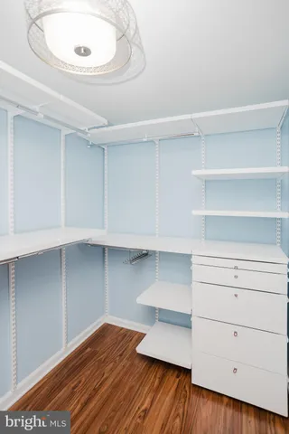 a view of storage and utility room with wooden floor