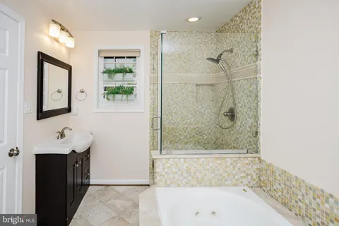 a bathroom with a bathtub and a shower