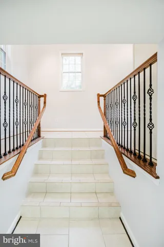 a view of staircase with white walls and a window