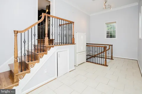 a view of staircase with white walls and a window