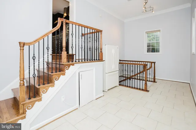 a view of staircase with white walls and a window