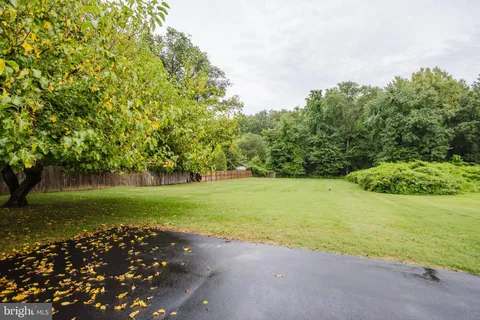 a view of a swimming pool with a patio and a yard
