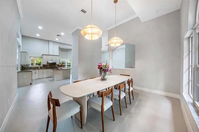 a bathroom with a granite countertop sink a toilet a mirror and bathtub