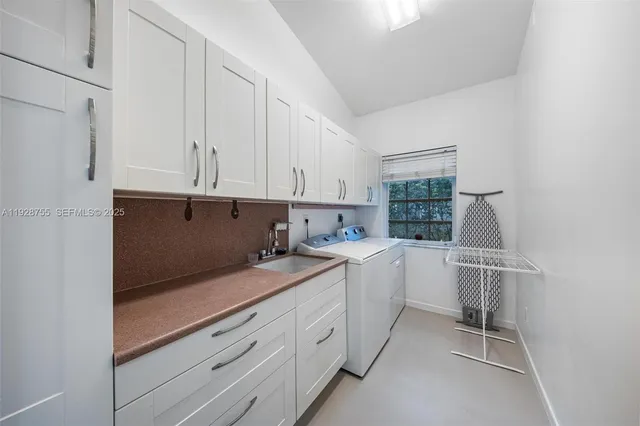 a view of a swimming pool with a table and chairs under an umbrella