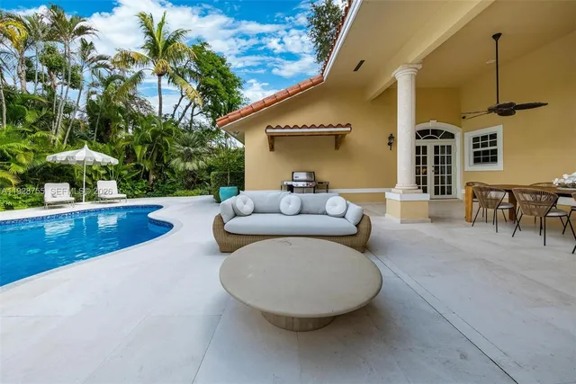 a view of a house with pool fire pit and sitting area