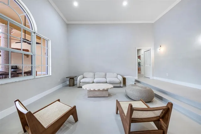 a view of a hallway with furniture and a chandelier