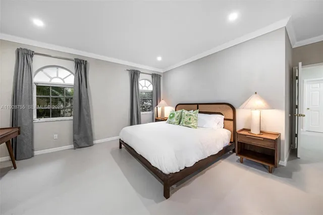 a spacious bedroom with a bed and a large window