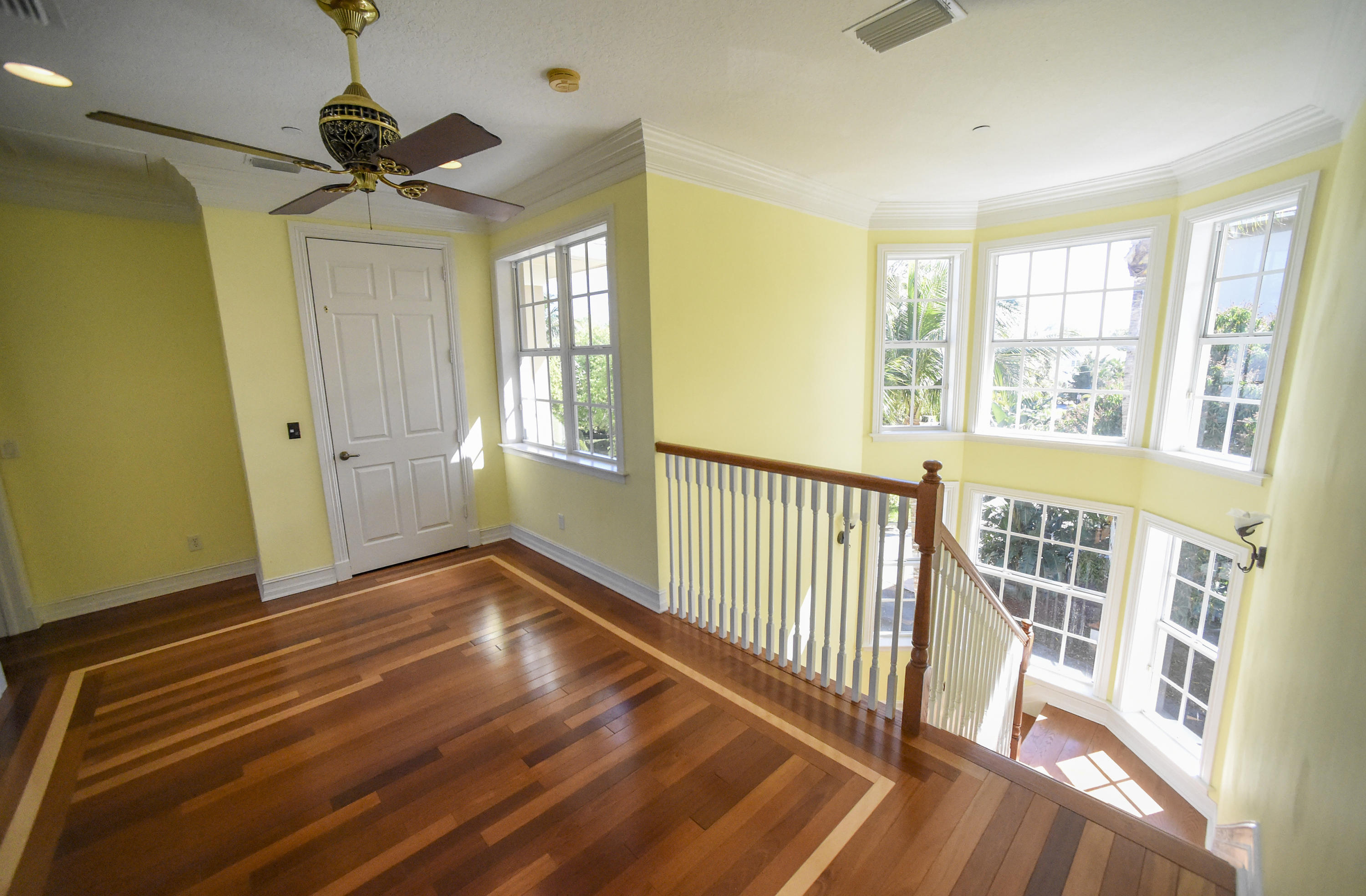 552 Southwest St Lucie Crescent Stuart, FL 34994 - Photo 11 of 36 a view of an empty room with a window and wooden floor