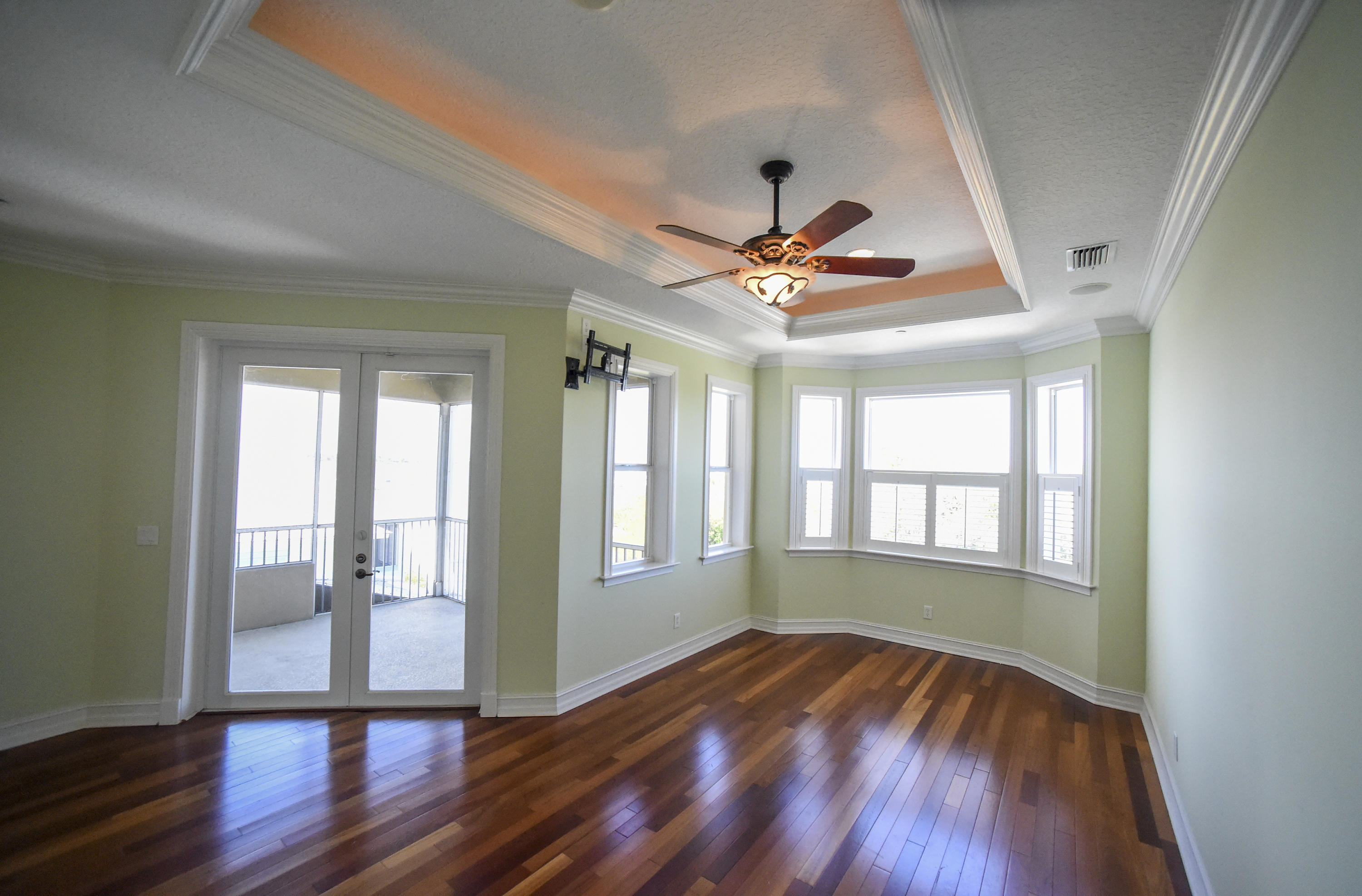 552 Southwest St Lucie Crescent Stuart, FL 34994 - Photo 12 of 36 a view of an empty room with wooden floor and a window