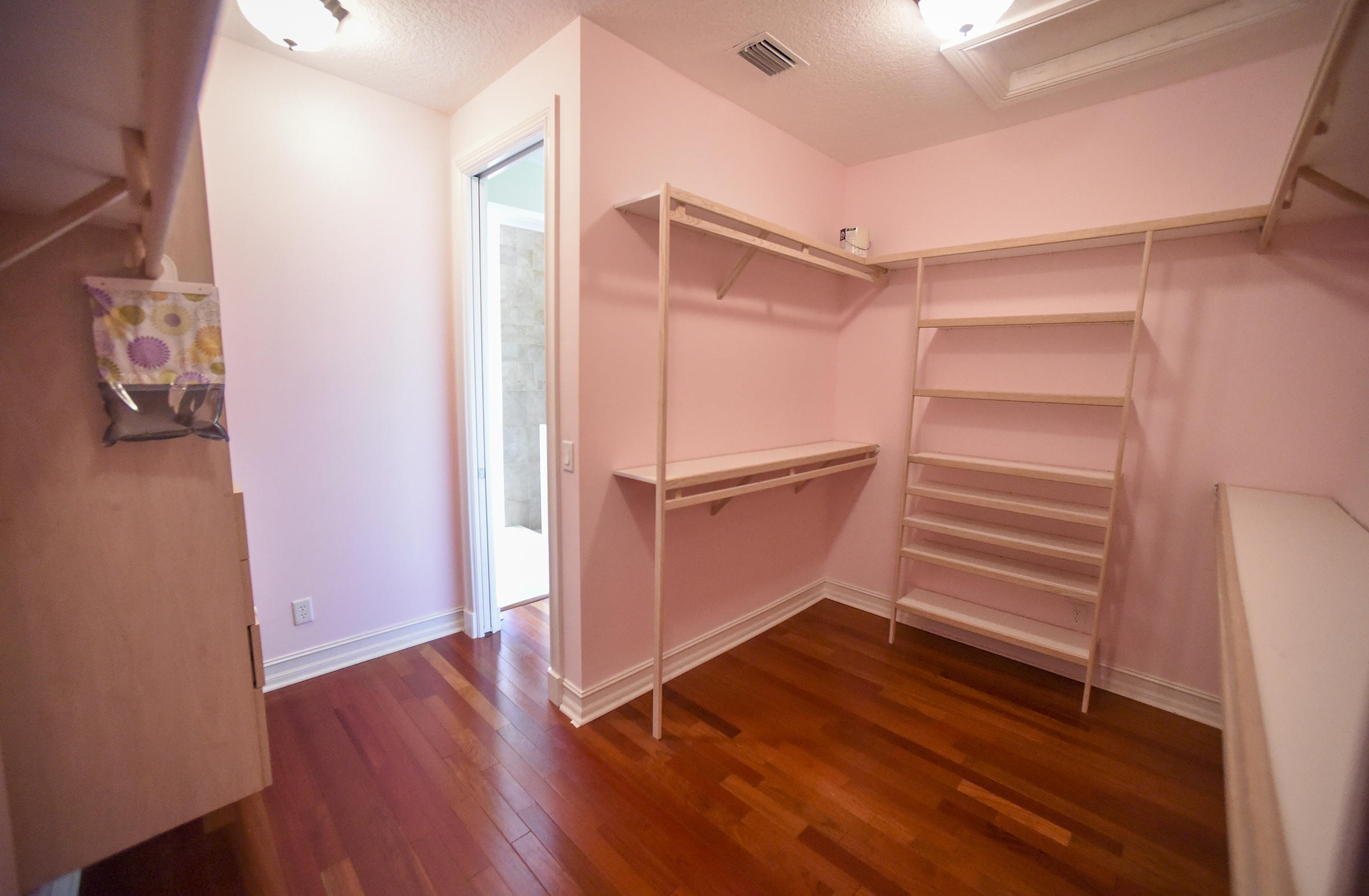 552 Southwest St Lucie Crescent Stuart, FL 34994 - Photo 14 of 36 a view of an empty room with wooden floor and a window